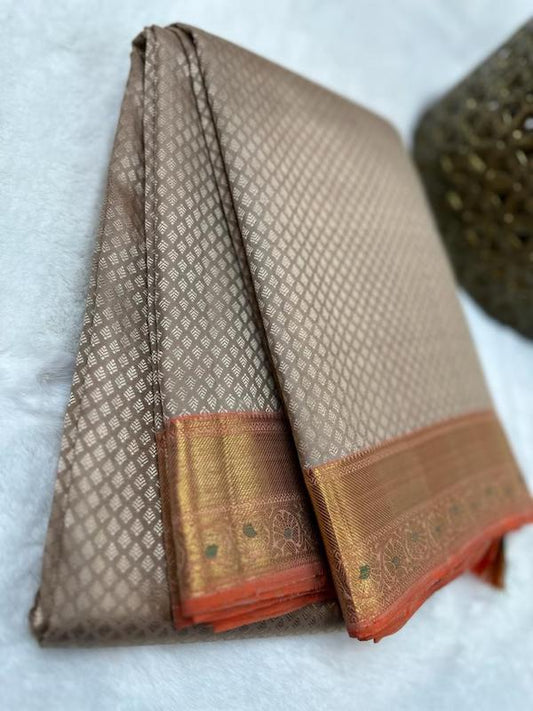 Brown Kanchipuram pure zari silk saree with orange border.